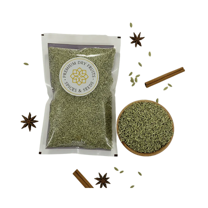 Packaged green fennel Lucknow with a bowl of spice and cinnamon sticks on a white background