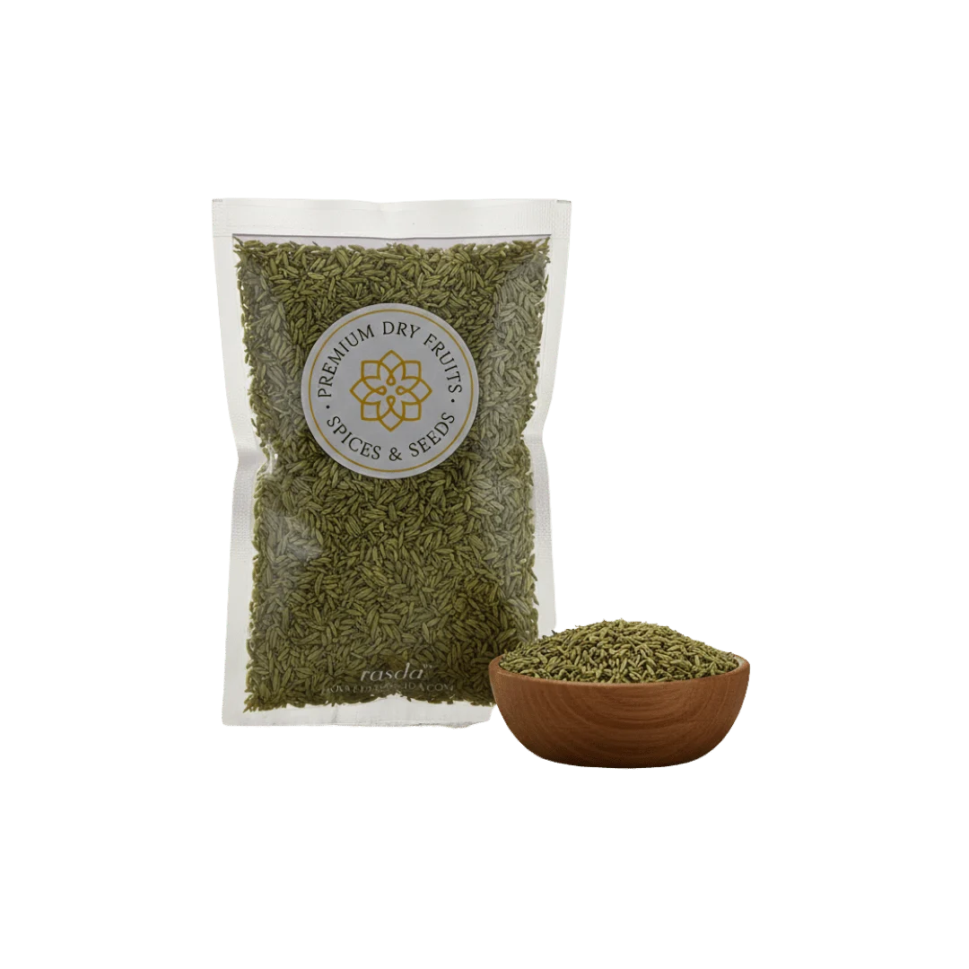 Packaged green fennel seeds with a bowl of spices on a white background