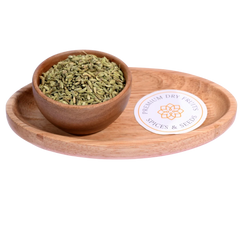 Fennel Seeds / Saunf in a wooden bowl showcase fresh, aromatic seeds for culinary use.