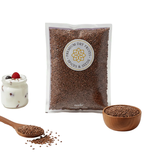 Premium flax seeds (alsi) pack with wooden bowl of flax seeds, spoon, and yogurt topped with seeds on green background