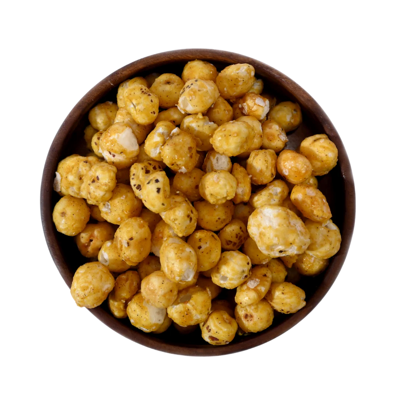 Fox Nuts Caramel Glazed Makhana are beautifully presented in a wooden bowl, showcasing their shiny caramel finish and crisp texture.