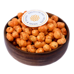 Crunchy and flavorful, Fox Nuts Fiery Peri Peri Spiced are roasted to perfection and coated with bold peri peri seasoning in a wooden bowl.