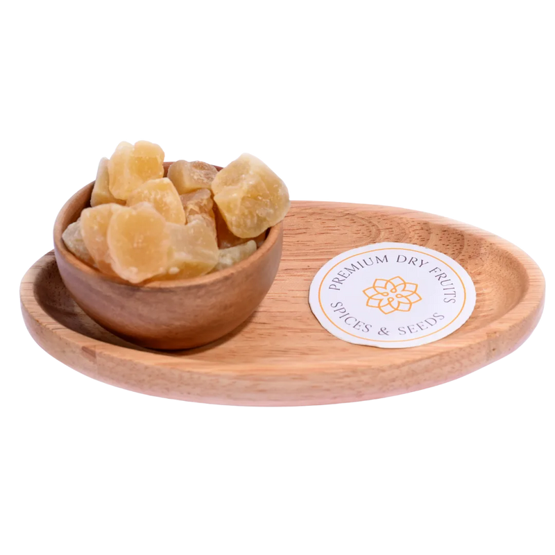 Golden yellow Ginger Candy Dry pieces displayed in a bowl, showcasing their crystallized texture and zesty flavor