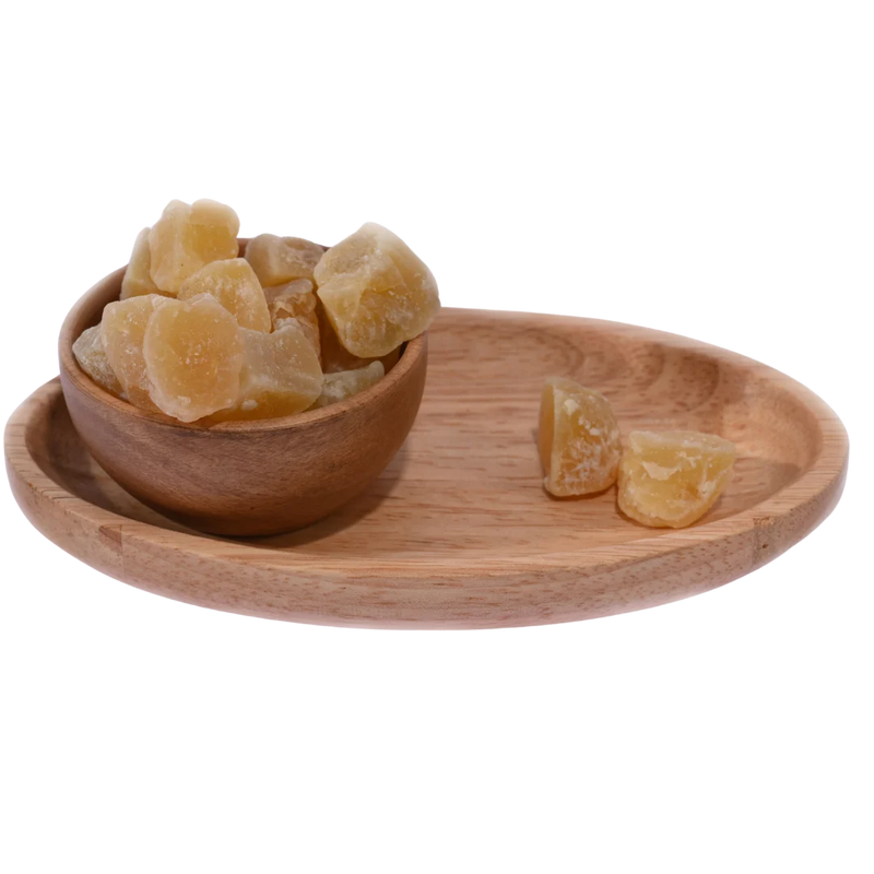 Ginger Candy Dry - Wooden bowl with ginger pieces on a wooden tray on a white background