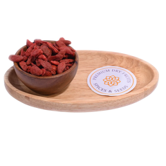 Goji Berries Dried in a wooden bowl showcasing their bright red-orange color and natural texture.