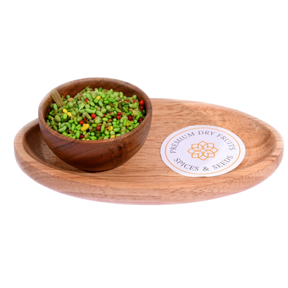 Green Mix Mouth Freshener in a wooden bowl highlights a vibrant mix of fennel seeds and herbs.
