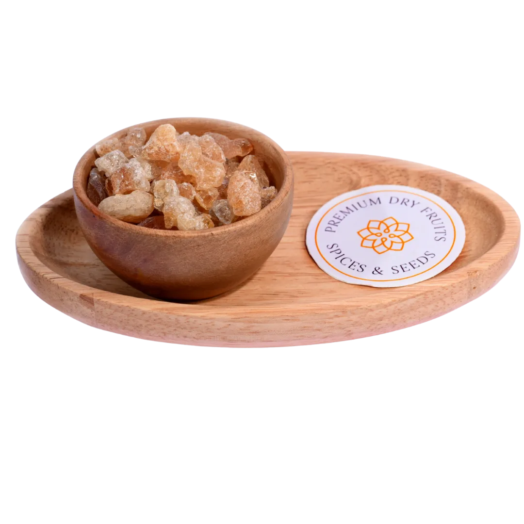 Gum or Gaundh in a wooden bowl showcases natural, crystal-like edible gum pieces.