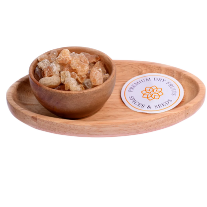 Gum or Gaundh in a wooden bowl showcases natural, crystal-like edible gum pieces.