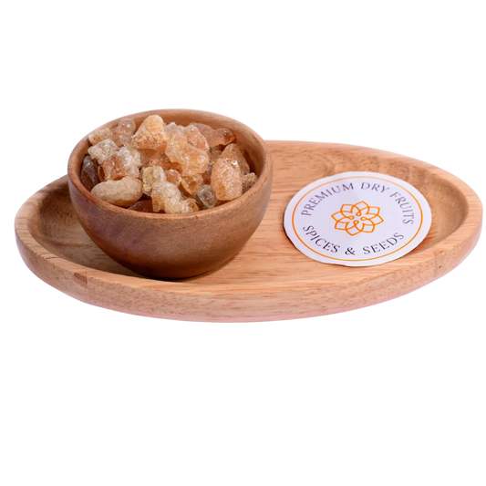 Gum or Gaundh in a wooden bowl showcases natural, crystal-like edible gum pieces.