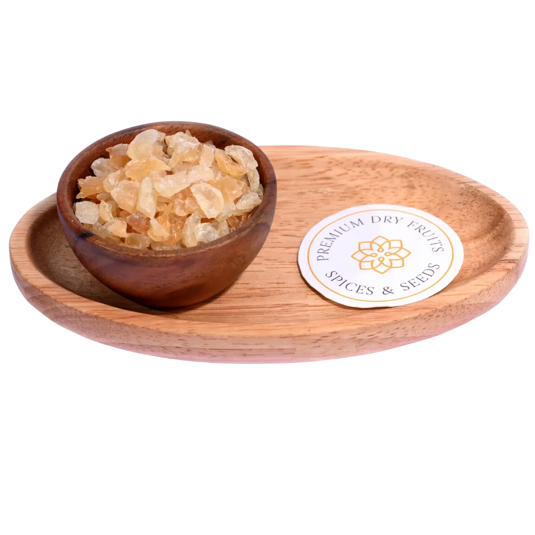 Gum Tragacanth or Gaundh Kateera in a wooden bowl showcases natural, translucent gum crystals.
