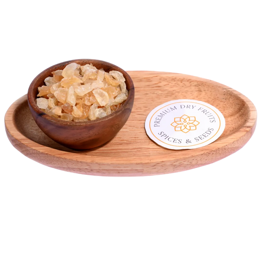 Gum Tragacanth or Gaundh Kateera in a wooden bowl showcases natural, translucent gum crystals.