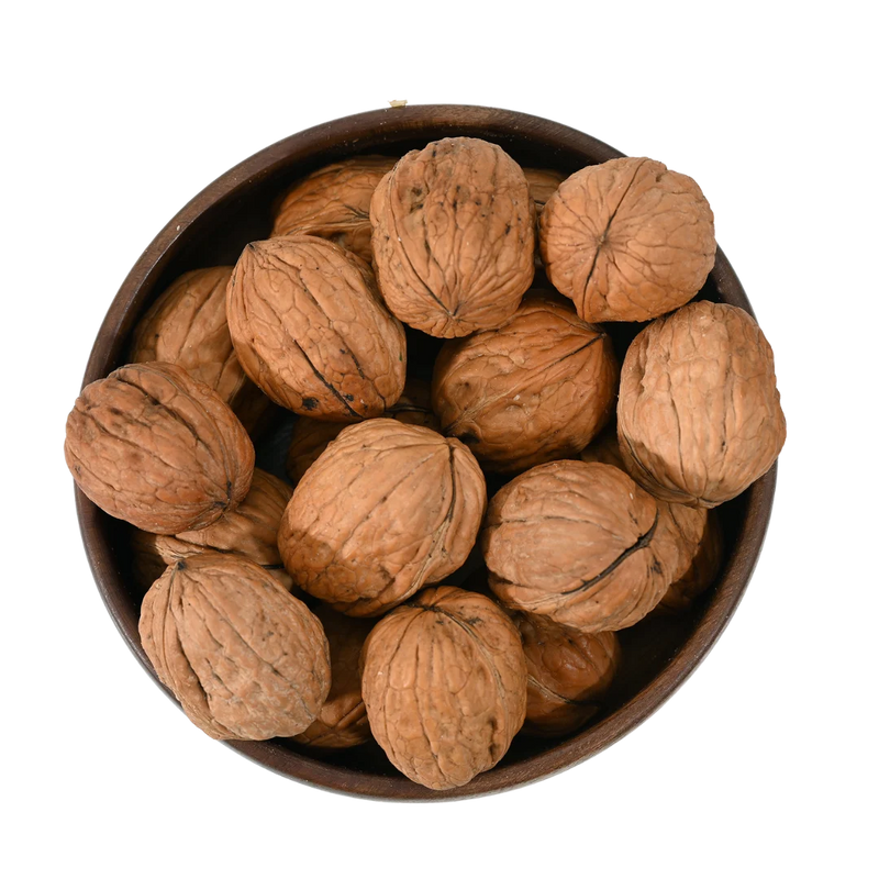 Pile of fresh inshell Chile walnuts, high-quality Akhrot nuts, natural texture