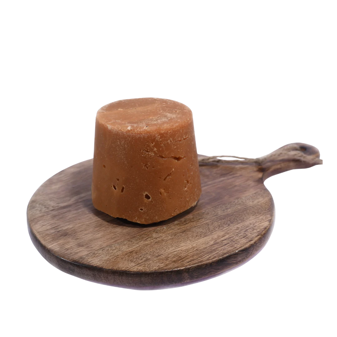 Organic Jaggery / Gud displayed in a rustic wooden bowl, perfect for healthy and traditional Indian recipes.