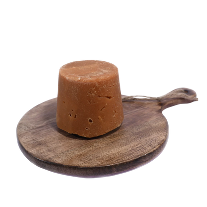 Organic Jaggery / Gud displayed in a rustic wooden bowl, perfect for healthy and traditional Indian recipes.