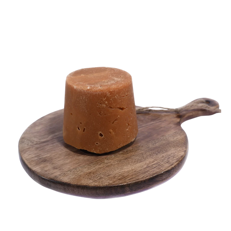 Organic Jaggery / Gud displayed in a rustic wooden bowl, perfect for healthy and traditional Indian recipes.