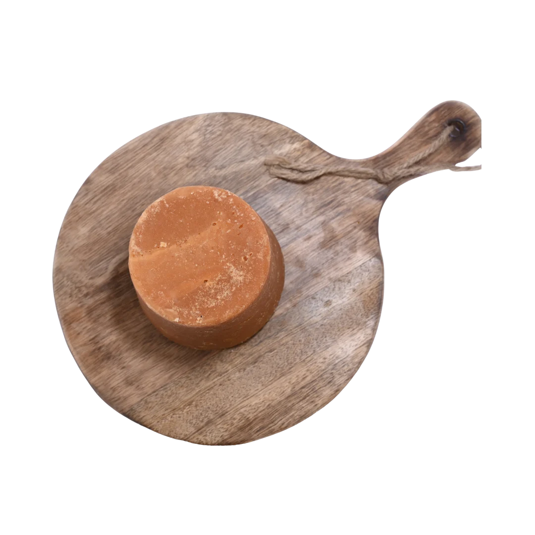 Premium quality Jaggery / Gud cubes in a wooden bowl, showing their deep caramel color and natural purity.