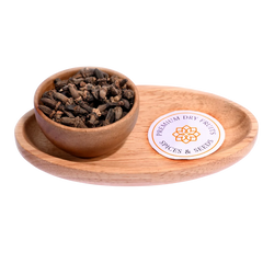 Kapok Buds / Marathi Moggu in a wooden bowl showcase dried, aromatic flower buds.