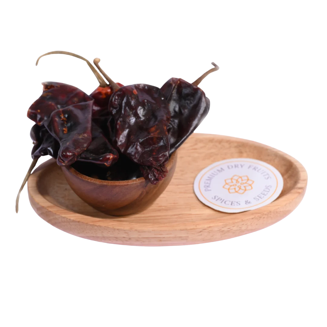 Kashmiri Chilli in a wooden bowl showcases vibrant red, mild, and aromatic spice flakes.
