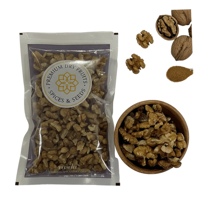 Packaged Kashmiri Walnuts (Akhrot) – Pieces with a bowl of walnuts and individual walnuts on a white background.