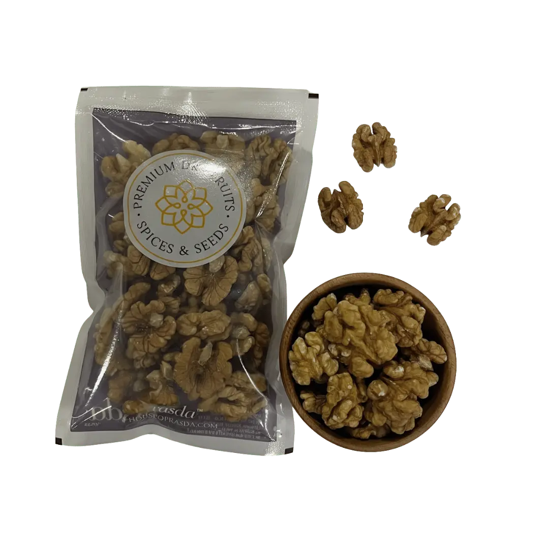 Premium Kashmiri walnuts in a bag beside a bowl filled with walnut halves, showcasing their rich texture and quality.
