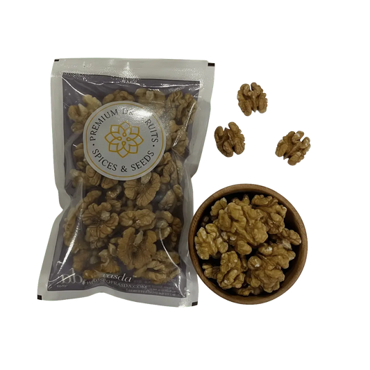 Premium Kashmiri walnuts in a bag beside a bowl filled with walnut halves, showcasing their rich texture and quality.