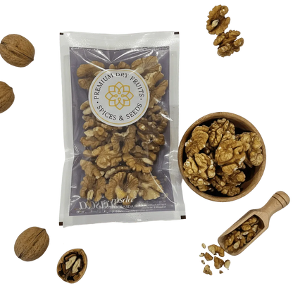 Packaged Kashmiri Walnuts (Akhrot) – Select Halves with a bowl, scoop, and scattered walnuts on a white background.