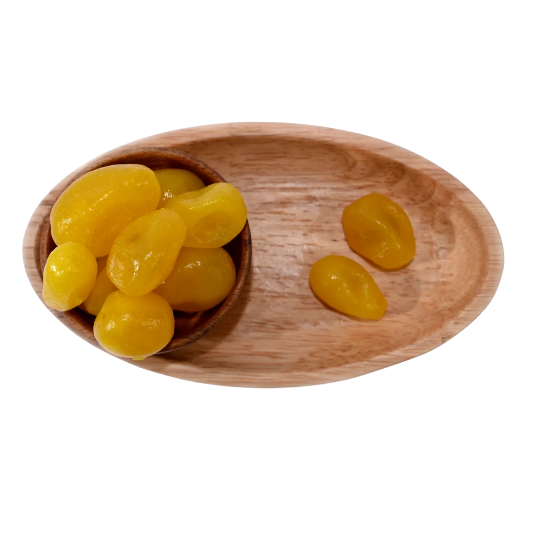 Wooden bowl with yellow candies on a wooden tray - Lemon Dehydrated