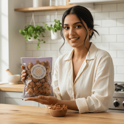 Woman holding Rasda premium mace javitri pack in modern kitchen setting