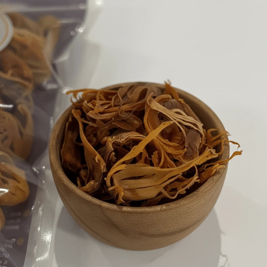 Rasda premium mace javitri being grated into soup with whole mace in wooden bowl