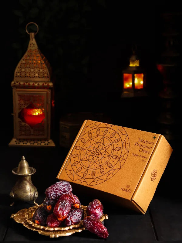 Box of Medjool Premium Dates with decorative lanterns in the background