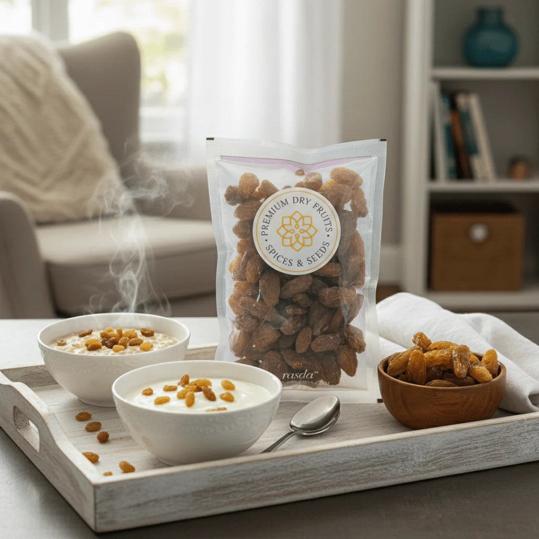 Tray with bowls of food, a bag of Munakka Raisins Premium, and a wooden bowl on a table.