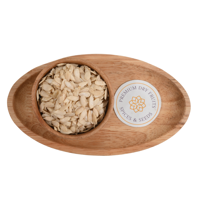 Close-up of high-quality kharbuja seeds or muskmelon seeds arranged in a rustic wooden bowl.