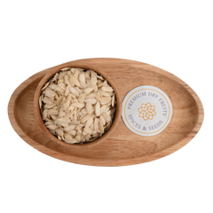 Close-up of high-quality kharbuja seeds or muskmelon seeds arranged in a rustic wooden bowl.