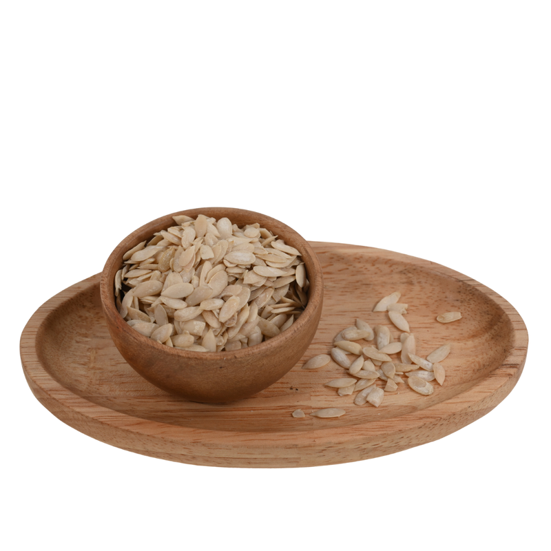 Top view of nutrient-rich muskmelon seeds in a polished wooden bowl, ready to use.