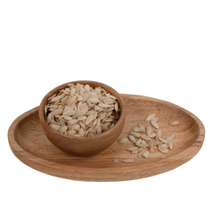 Top view of nutrient-rich muskmelon seeds in a polished wooden bowl, ready to use.