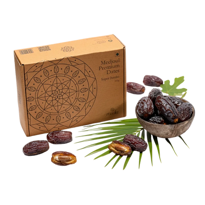 Box of Medjoul Premium Dates with dates and palm leaves on a white background