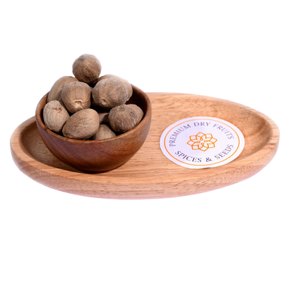 Nutmeg or Jaiphal in a wooden bowl showcases whole, premium-quality spice seeds.