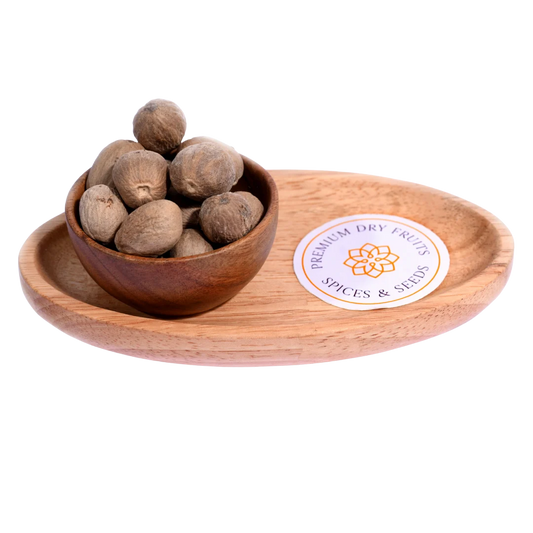 Nutmeg or Jaiphal in a wooden bowl showcases whole, premium-quality spice seeds.