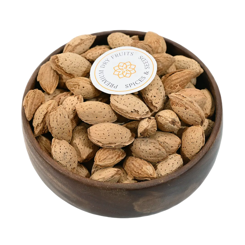 Paper Shell Almonds/ Thin Shelled Almonds/ Kagzi Badam - Wooden bowl filled with almonds on a white background, featuring a brand label.