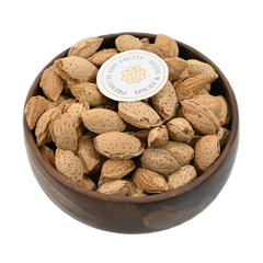 Paper Shell Almonds/ Thin Shelled Almonds/ Kagzi Badam - Wooden bowl filled with almonds on a white background, featuring a brand label.