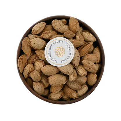Paper Shell Almonds/ Thin Shelled Almonds/ Kagzi Badam - Wooden bowl filled with almonds on a white background