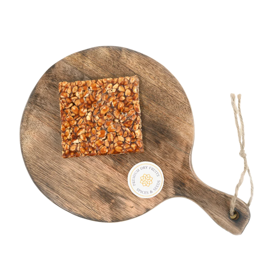 Peanut Chikki on wooden plate traditional Indian sweet made with roasted peanuts and jaggery healthy crunchy snack