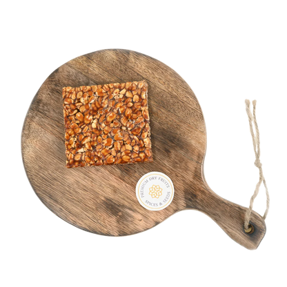 Peanut Chikki on wooden plate traditional Indian sweet made with roasted peanuts and jaggery healthy crunchy snack
