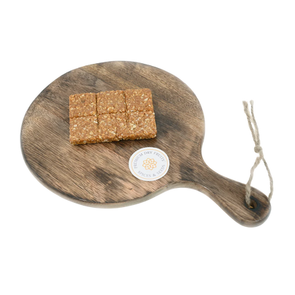 Peanut Crush Chikki on wooden plate traditional Indian sweet made with crushed peanuts and jaggery healthy crunchy