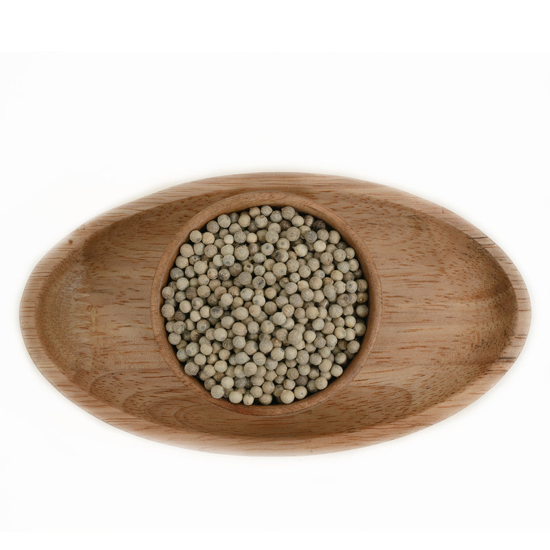 Premium White pepper corns displayed in a wooden bowl 