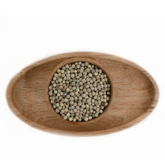 Premium White pepper corns displayed in a wooden bowl 