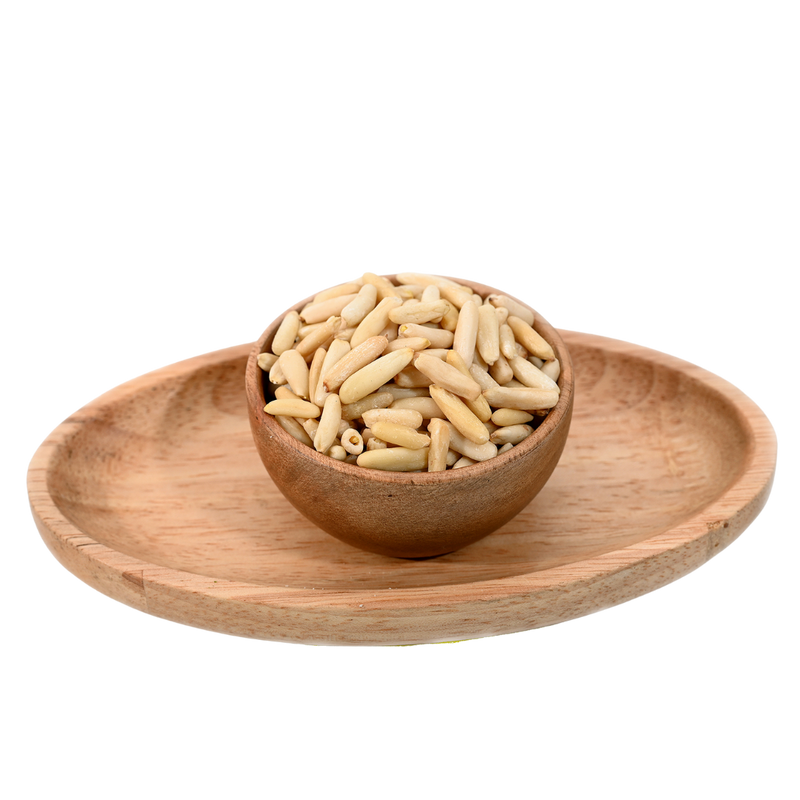 Pine nuts without shell in a wooden bowl.