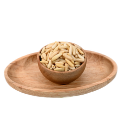 Pine nuts without shell in a wooden bowl.