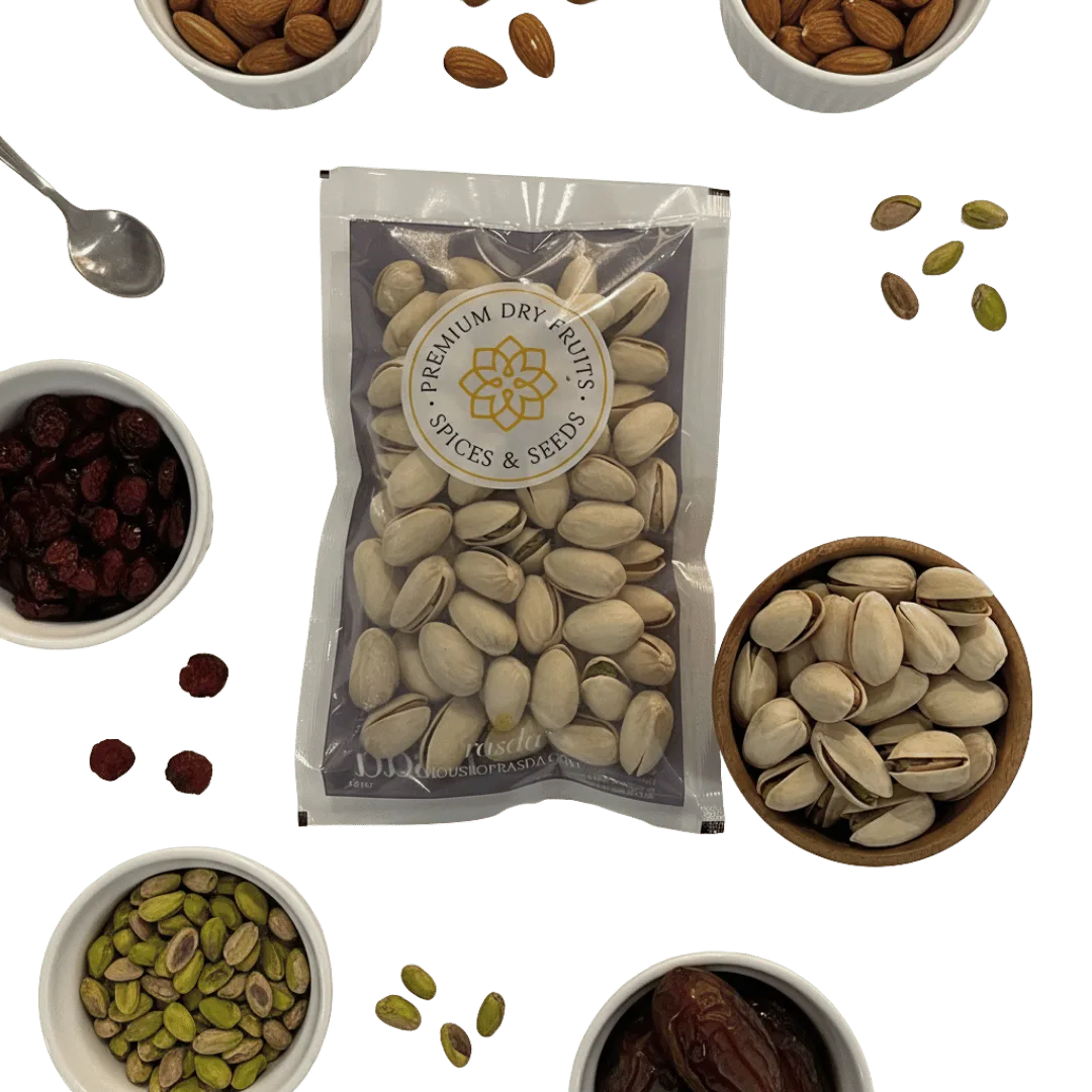 Packaged pistachios with a brand label surrounded by various dry fruits on a white background