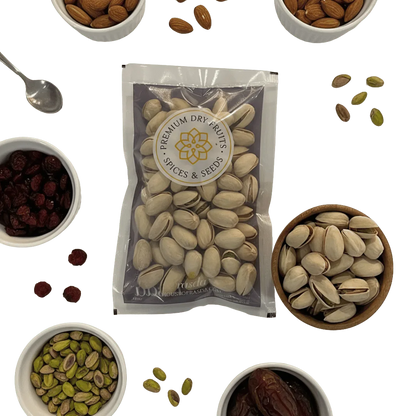 Packaged pistachios with a brand label surrounded by various dry fruits on a white background